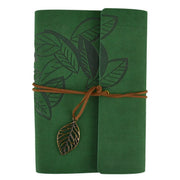 Green notebook with leaf design and brown string on a white background