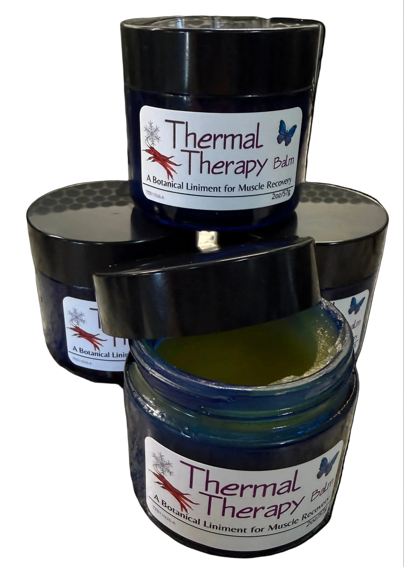 Three jars of 'Thermal Therapy Balm' on a countertop.