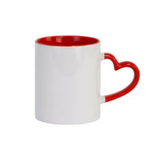 A white ceramic mug with a red interior and a red handle shaped like a heart, shown on a plain white background.