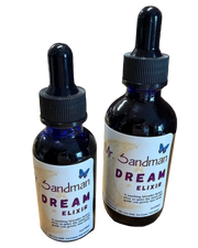 Two bottles of 'Dream Elixir' by Mr. Sandman on a wooden surface with a brick wall background.