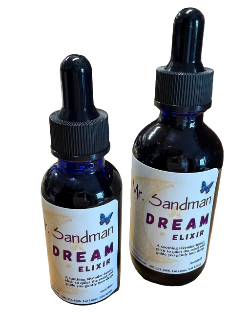 Two bottles of 'Dream Elixir' by Mr. Sandman on a wooden surface with a brick wall background.